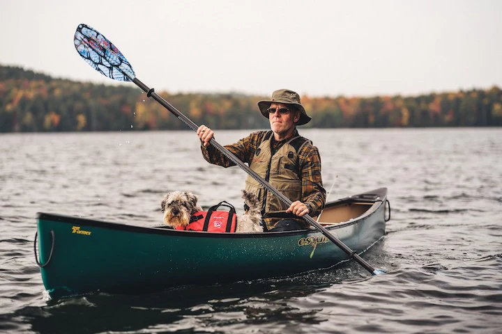 man riding a canoe