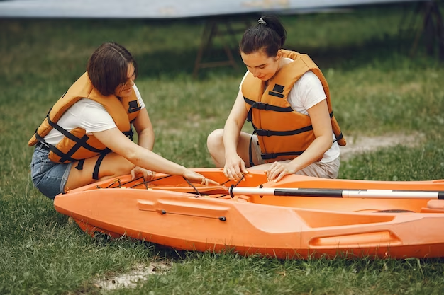 Two women dealing with a canoe