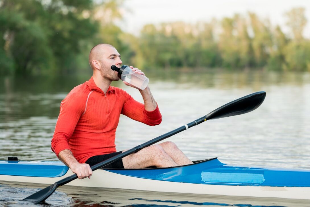Man drinking water in kayak