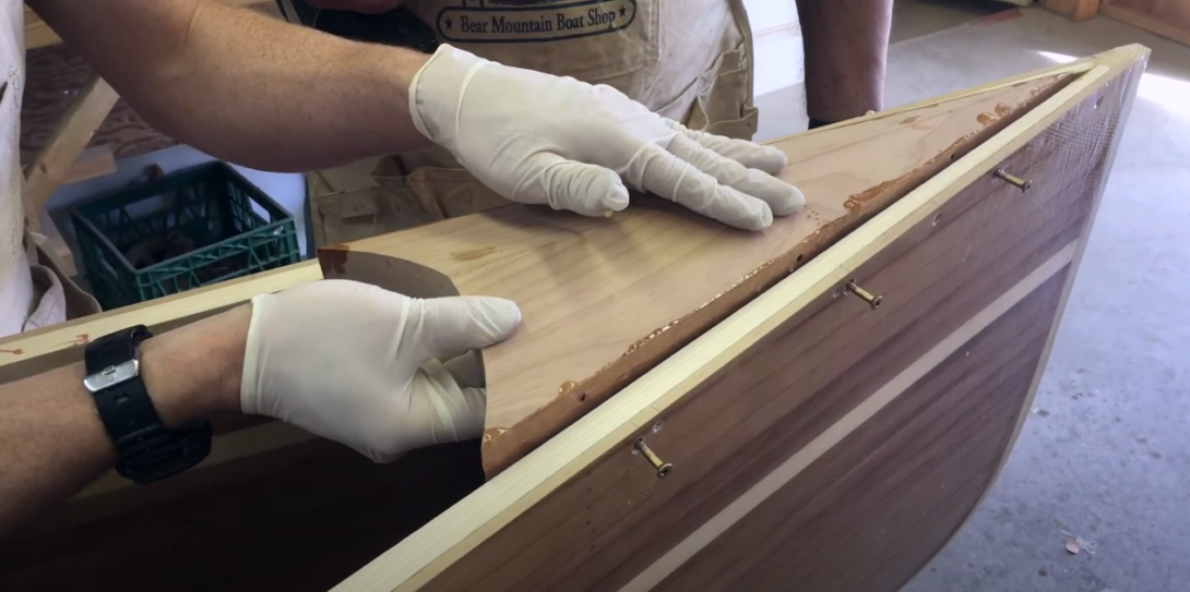 hand with gloves installing canoe deck