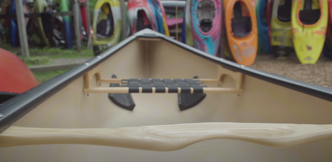 A close-up photo of a canoe and other canoes visible in the background