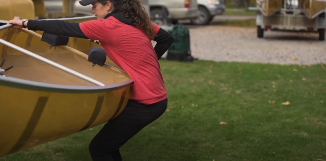 Woman lifting a canoe