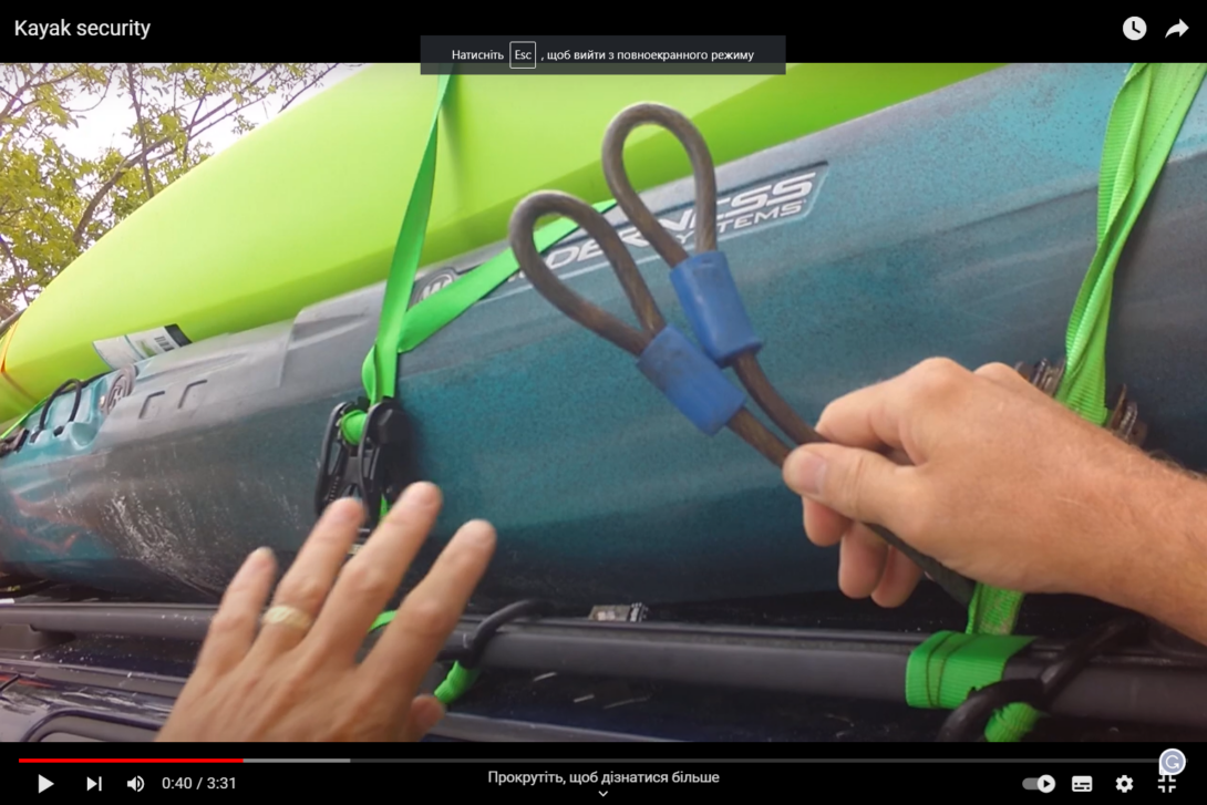 A man pulls a cable through a kayak on the trunk