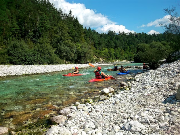 People floating in kayaks on a river